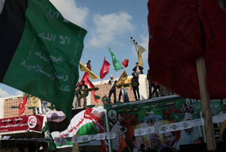 A celebratory pro-unity march Sunday in Gaza City. Three different groups’ flags can be seen.(Mahmud Hams/AFP/Getty Images)