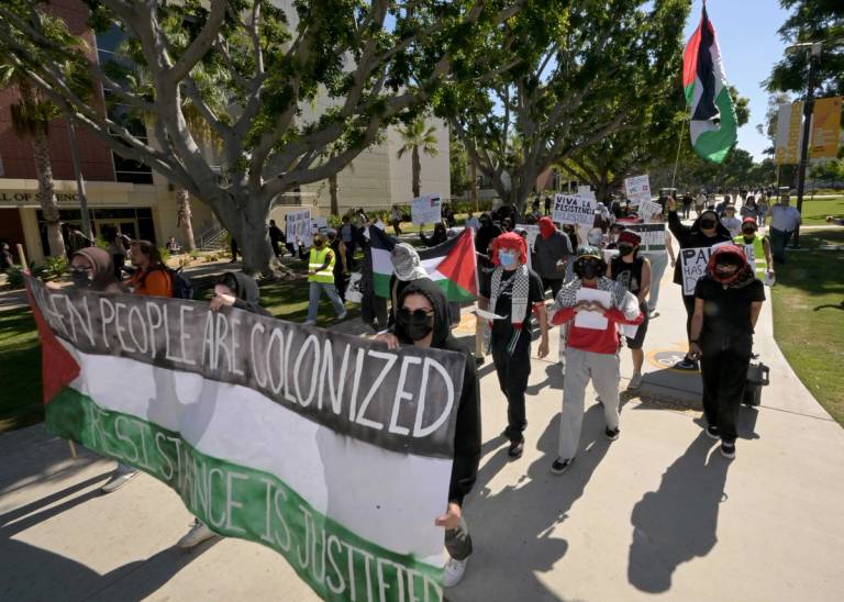 LA F.U.E.R.Z.A, a student-run advocacy group, marched through the campus of CSU Long Beach for a 'day of resistance' protest for Palestine on Oct. 10, 2023. The majority of participants wore face coverings and refused to speak with media but they did periodically stop and give speeches.