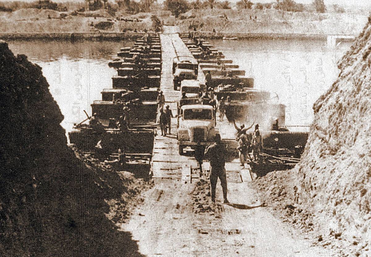 Egyptian military trucks cross a bridge laid over the Suez Canal on October 7, 1973. (Wikimedia)