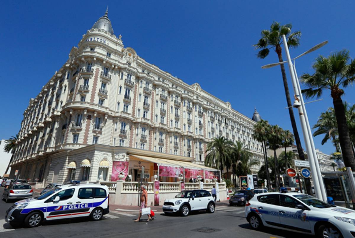 Police cars are parked outside the Carlton Hotel on July 28, 2013 in the French Riviera resort of Cannes, after an armed man held up the jewellery exhibition 'Extraordinary diamonds' of the Leviev diamond house, making away with jewels estimated to be worth about 40 million euros ($53 million), according to investigators. (VALERY HACHE/AFP/Getty Images)