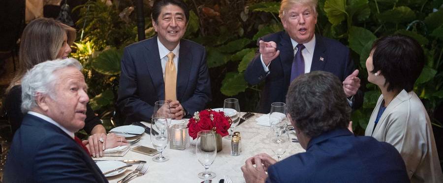US President Donald Trump, Japanese Prime Minister Shinzo Abe (2nd-L), his wife Akie Abe (R), US First Lady Melania Trump (L) and Robert Kraft (2nd-L),owner of the New England Patriots, sit down for dinner at Trump's Mar-a-Lago resort on February 10, 2017.