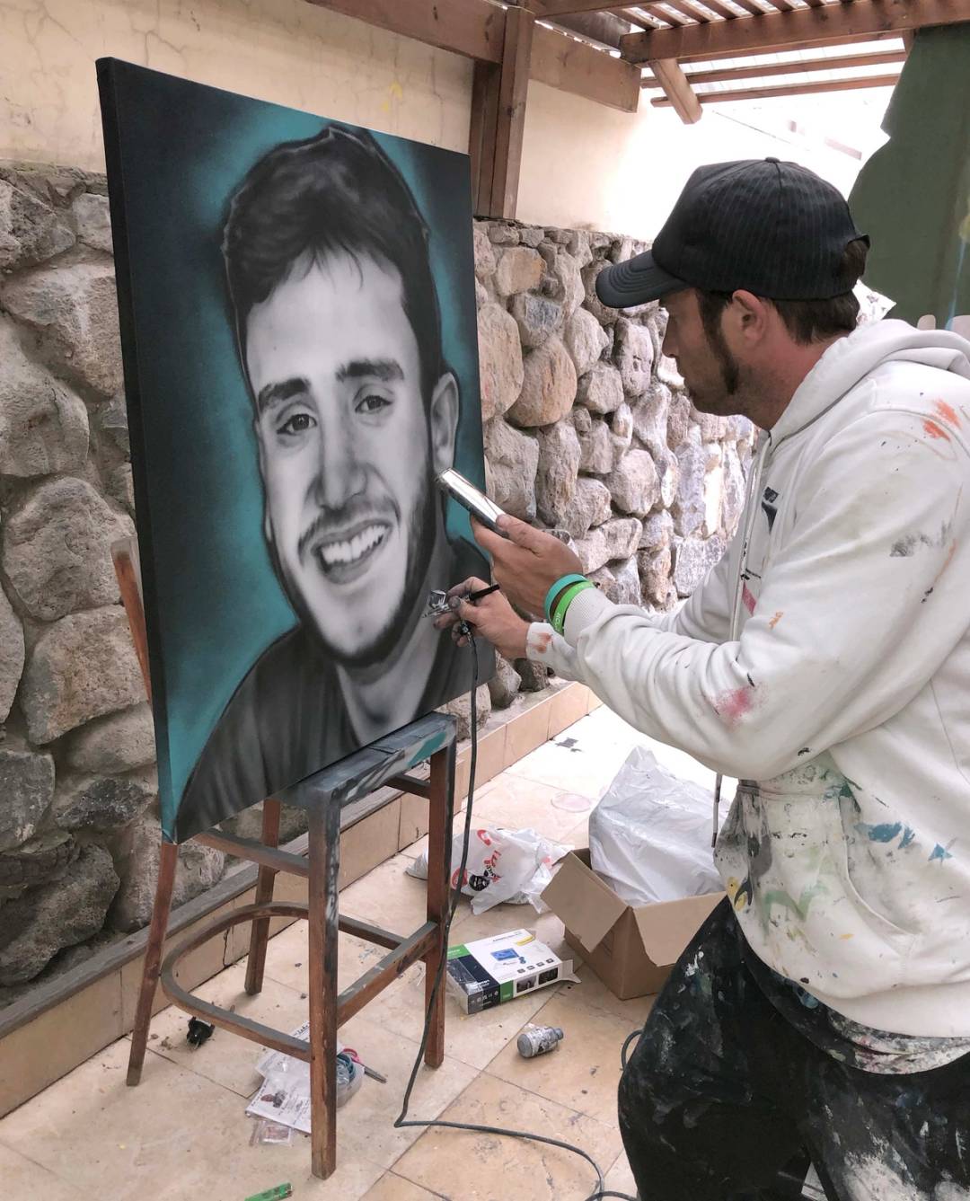 Artist Benzi Brofman completes a portrait of Reef Harush, a sergeant in the IDF who was killed in Gaza