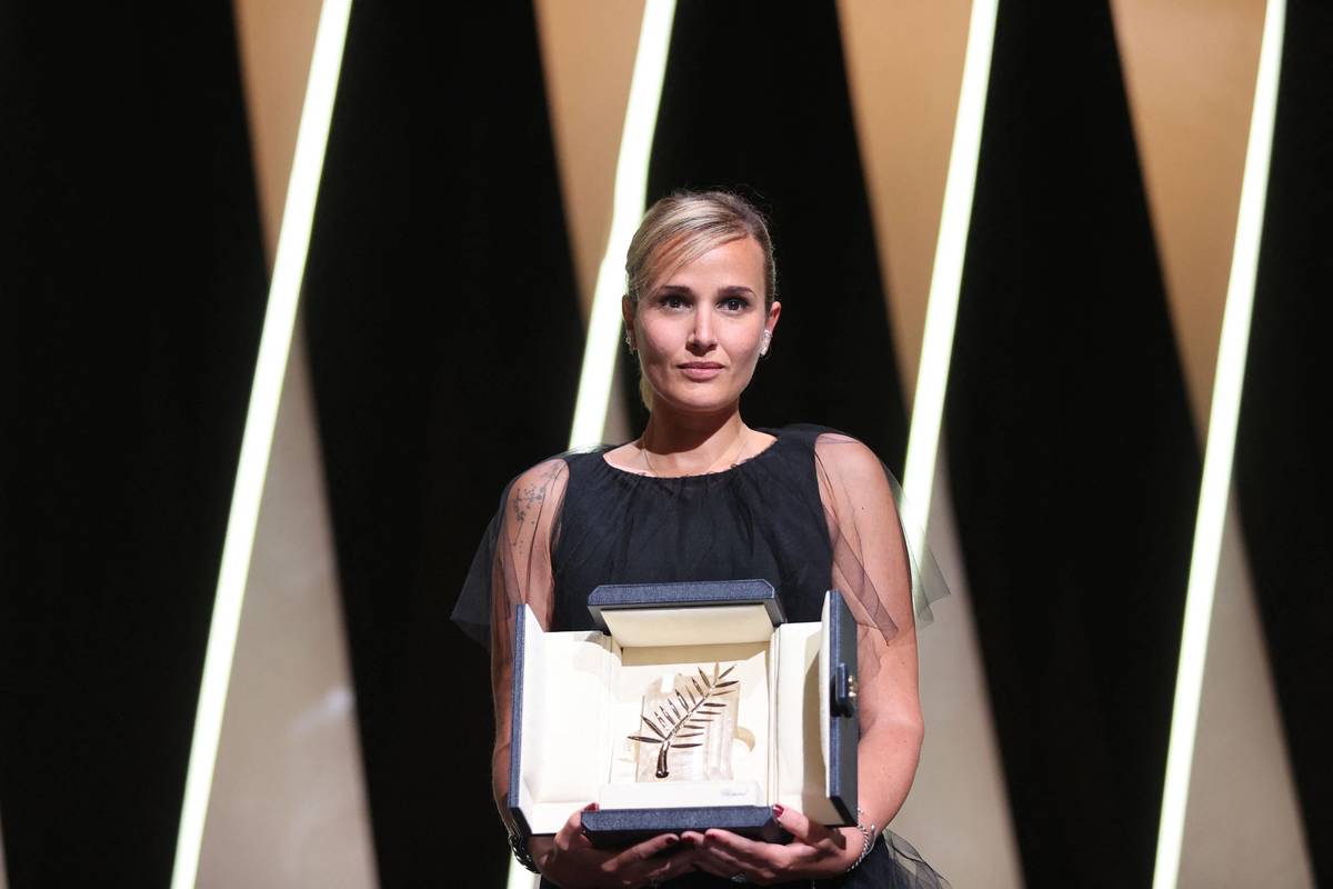 French director Julia Ducournau poses on stage with her trophy after she won the Palme d’Or for her film ‘Titane’ during the closing ceremony of the 74th edition of the Cannes Film Festival in France, on July 17, 2021