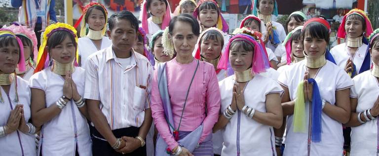 Myanmar's State Counselor Aung San Suu Kyi poses with locals at Daw Hsan Boon village in Loikaw on December 29, 2017.