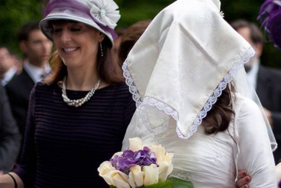 The author (left) at her daughter's wedding, walking with the veiled bride.