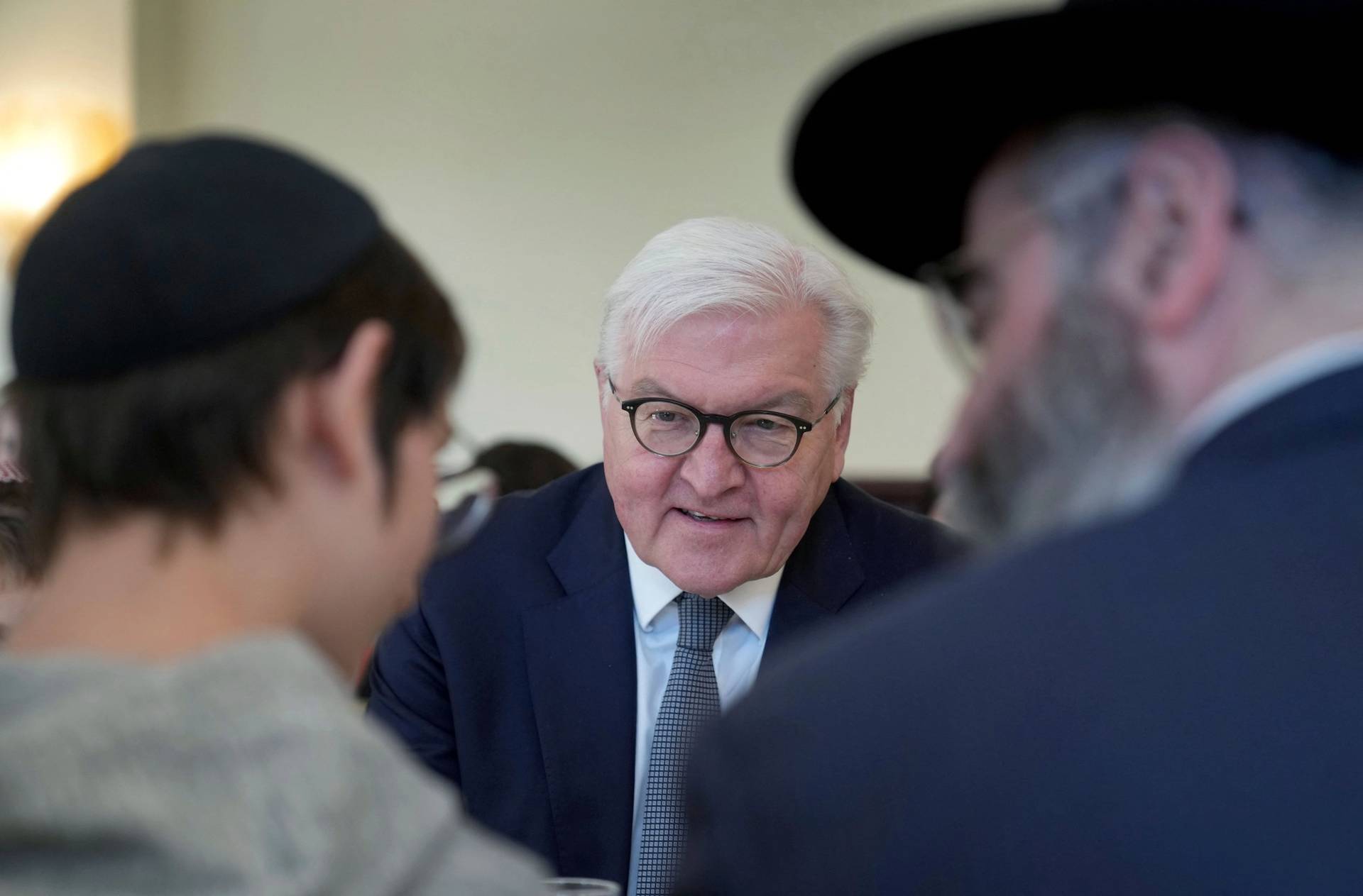 German President Frank-Walter Steinmeier talks with refugees from Odessa at the Szloma-Albam-House, the Jewish community center in Berlin, on March 7, 2022