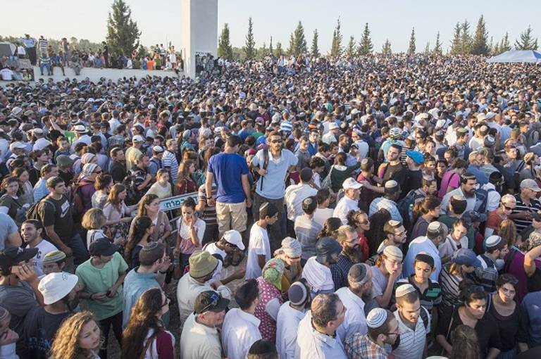Tens of thousands Israelis attend the joint funeral of Gilad Shaer, 16, Naftali Frenkel, 16, and Eyal Ifrach, 19, in the central Israeli town of Modiin on July 1, 2014. (Getty Images)