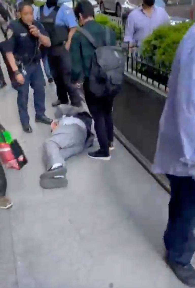 A man lies on the ground after a small explosion in New York City’s Diamond District, May 20, 2021