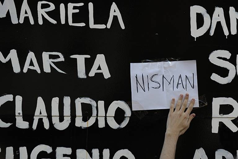 A man adds a sign that reads 'Nisman' to a list of victims of the 1994 AMIA bombing in Buenos Aires. (ALEJANDRO PAGNI/AFP/Getty Images)
