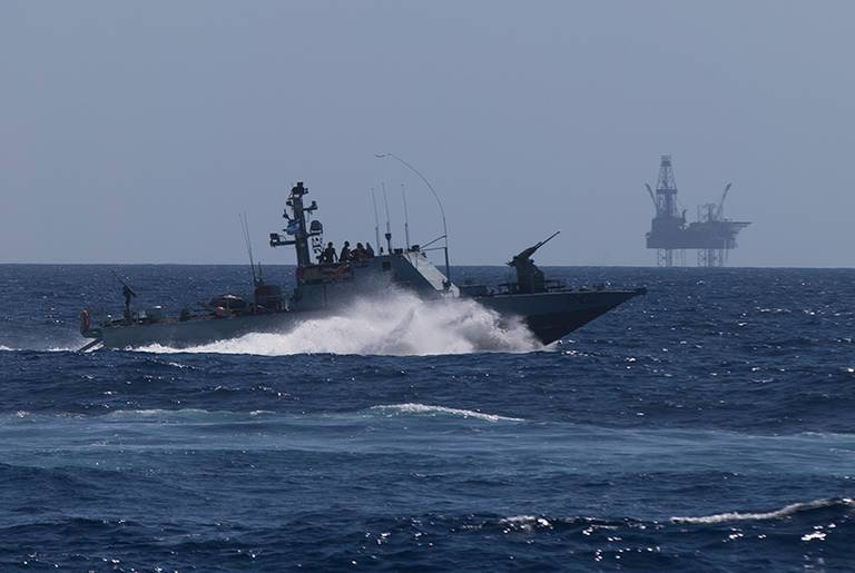An Israeli Navy vessel passes by the Tamar natural-gas production platform during a squadron exercise on May 27, 2013, off the coast of Israel in the Mediterranean Sea.(Uriel Sinai/Getty Images)