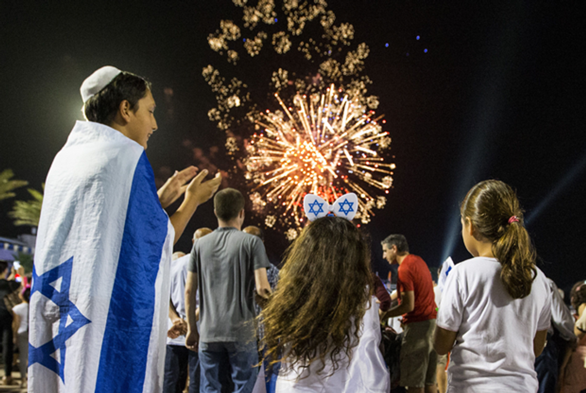 Israeli children watch fireworks in the Mediterranean coastal city of Netanya, on May 5, 2014, during Israel's 66th Independence Day celebrations. Israel's first Prime Minister David Ben-Gurion declared the existence of the State of Israel in Tel Aviv in 1948, ending the British mandate. (Jack Guez/AFP/Getty Images )
