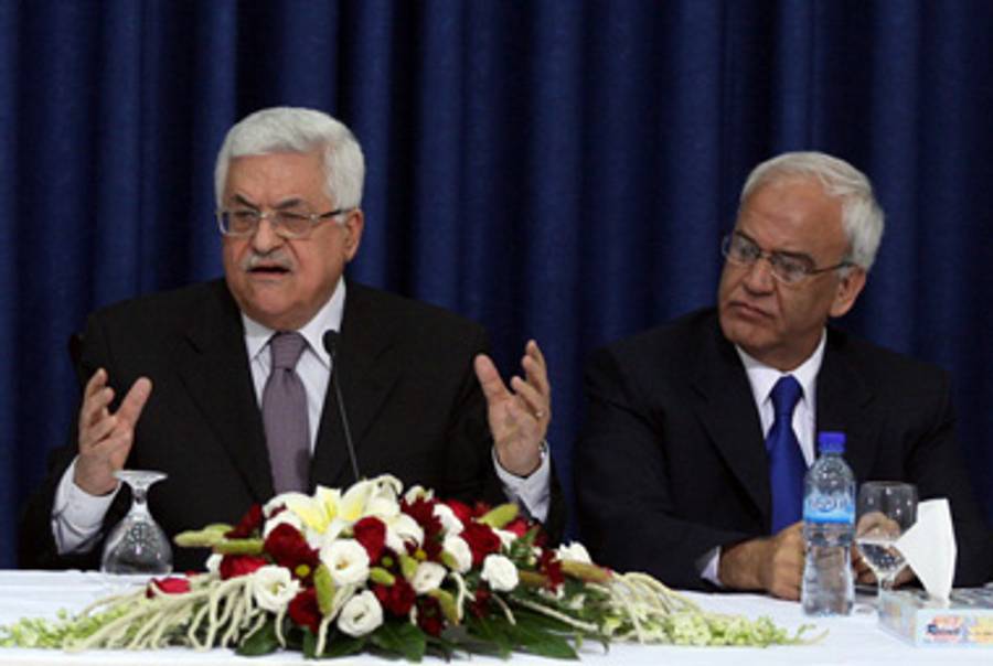 President Abbas (L) yesterday (on the right is Saeb Erekat, who nominally resigned earlier this year).(Abbas Momani/AFP/Getty Images)