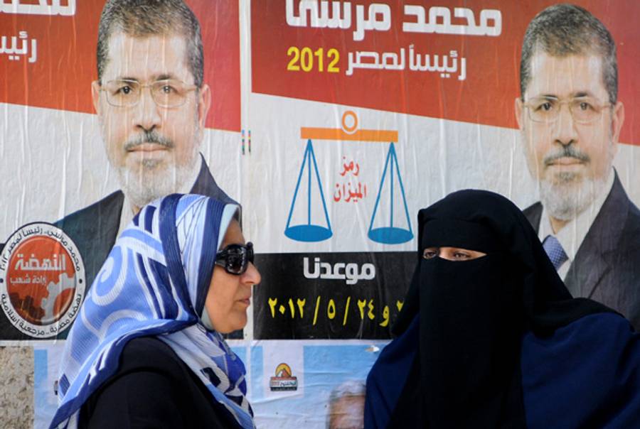 Muhammed Mursi campaign posters at a polling station yesterday.(STR/AFP/GettyImages)