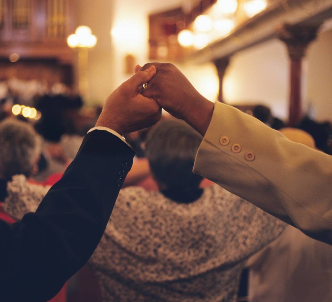 Congregation members hold hands at the Mother Bethel African Methodist Episcopal Church, Philadelphia, PA