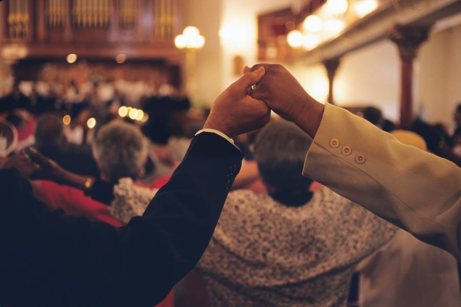 Congregation members hold hands at the Mother Bethel African Methodist Episcopal Church, Philadelphia, PA