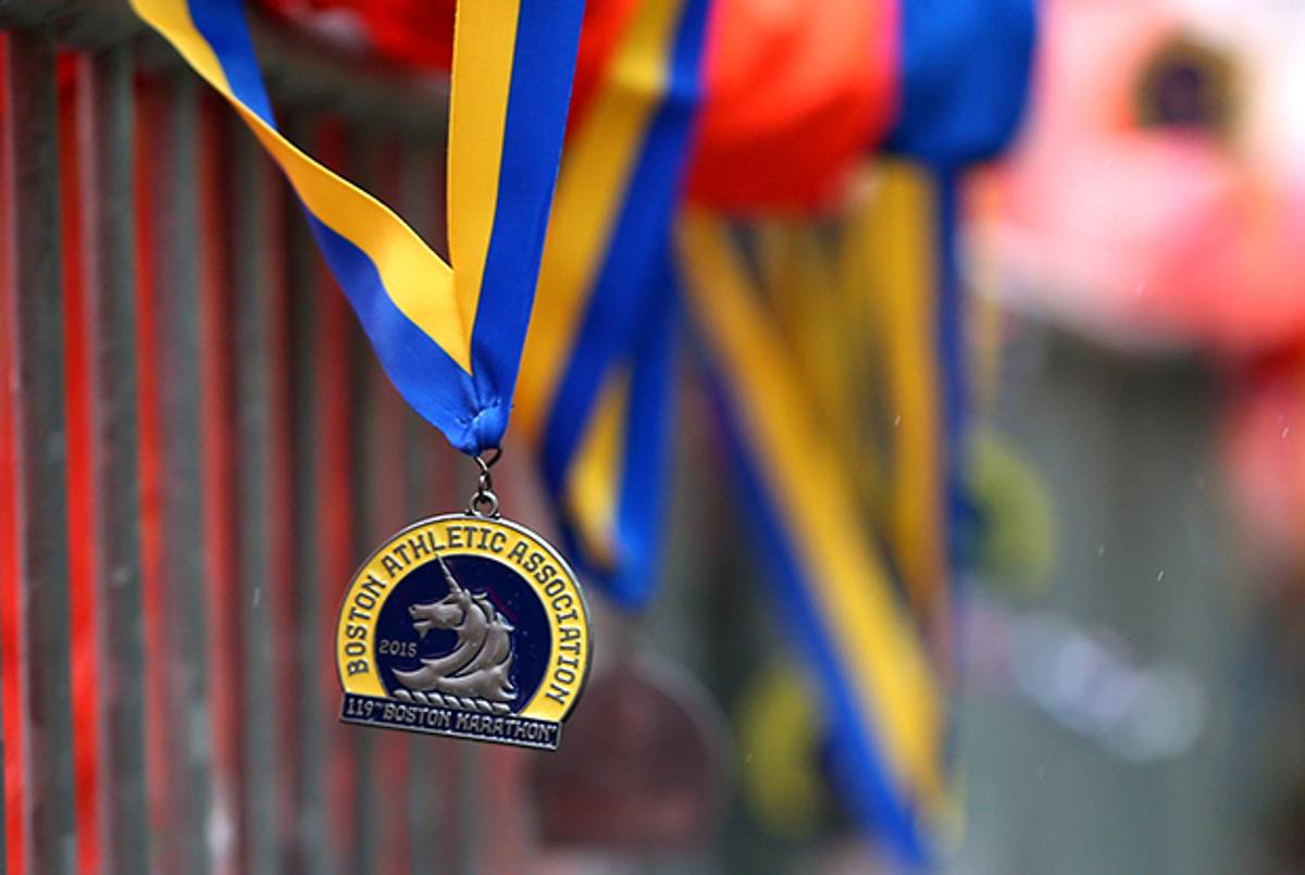A volunteer waits to give a finisher their medal during the 119th Boston Marathon on April 20, 2015 in Boston, Massachusetts. (Jim Rogash/Getty Images)