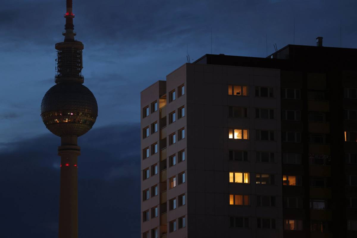 The broadcast tower at Alexanderplatz in Berlin stands without illumination behind an apartment building on Sept. 8, 2022