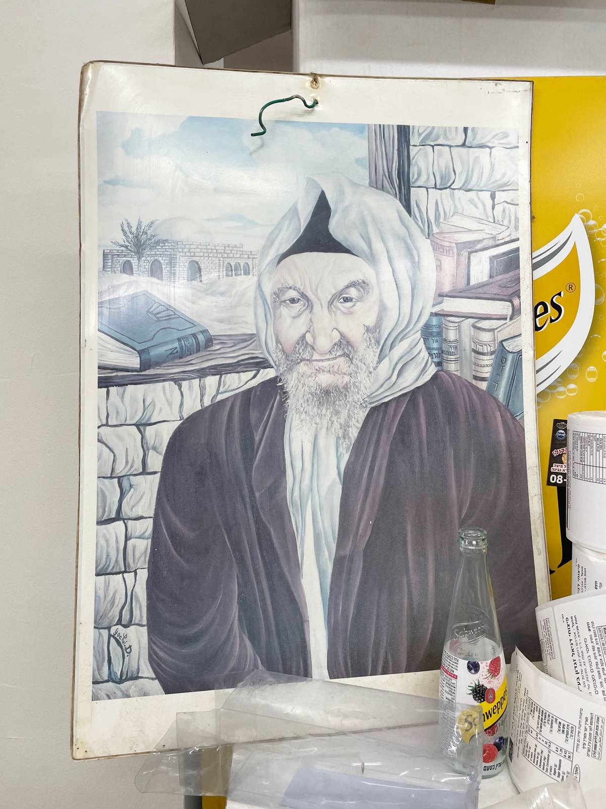 The Baba Sali gazes upon patrons at a store in Netivot