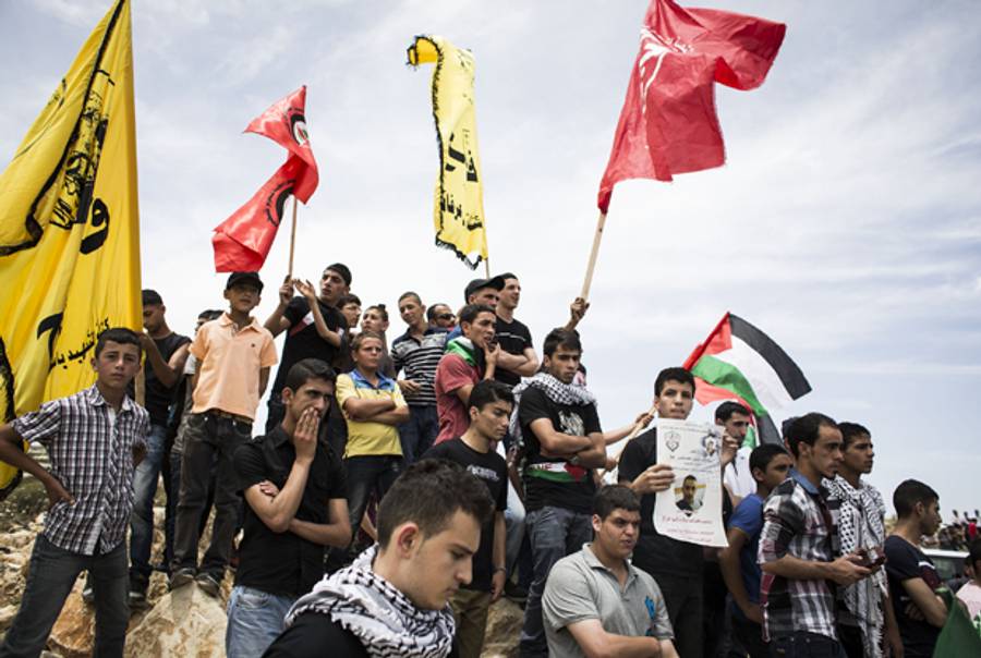 Family members and supporters attend the funeral of two Palestinian youths, Nadim Seeam Abu Kara and Muhammad abu da'har, on May 16, 2014 in Ramallah, West Bank. (Ilia Yefimovich/Getty Images)