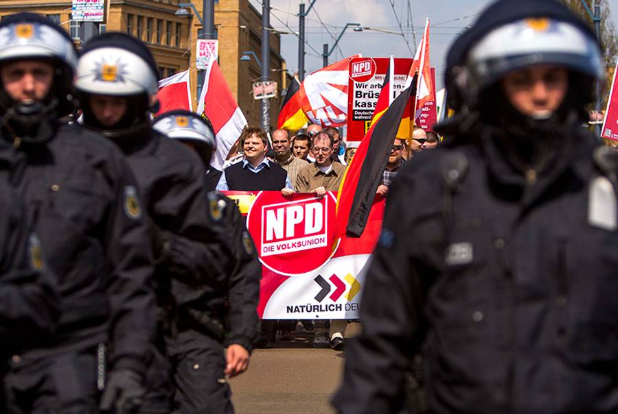Supporters of the far-right NPD political party wave flags as they demonstrate in the Schoeneweide district of Berlin, Germany, on May 1, 2013. (Carsten Koall)