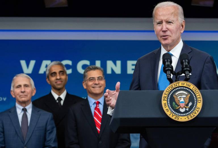From left: Anthony Fauci, Vivek Murthy, and HHS Secretary Xavier Becerra look on as Joe Biden delivers remarks ahead of receiving a COVID-19 booster on Oct. 25, 2022
