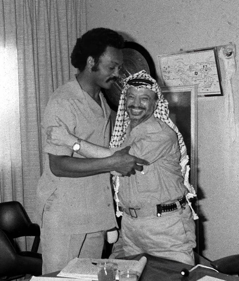 Yasser Arafat, right, and Rev. Jesse Jackson embrace before their meeting in Beirut, September 1979