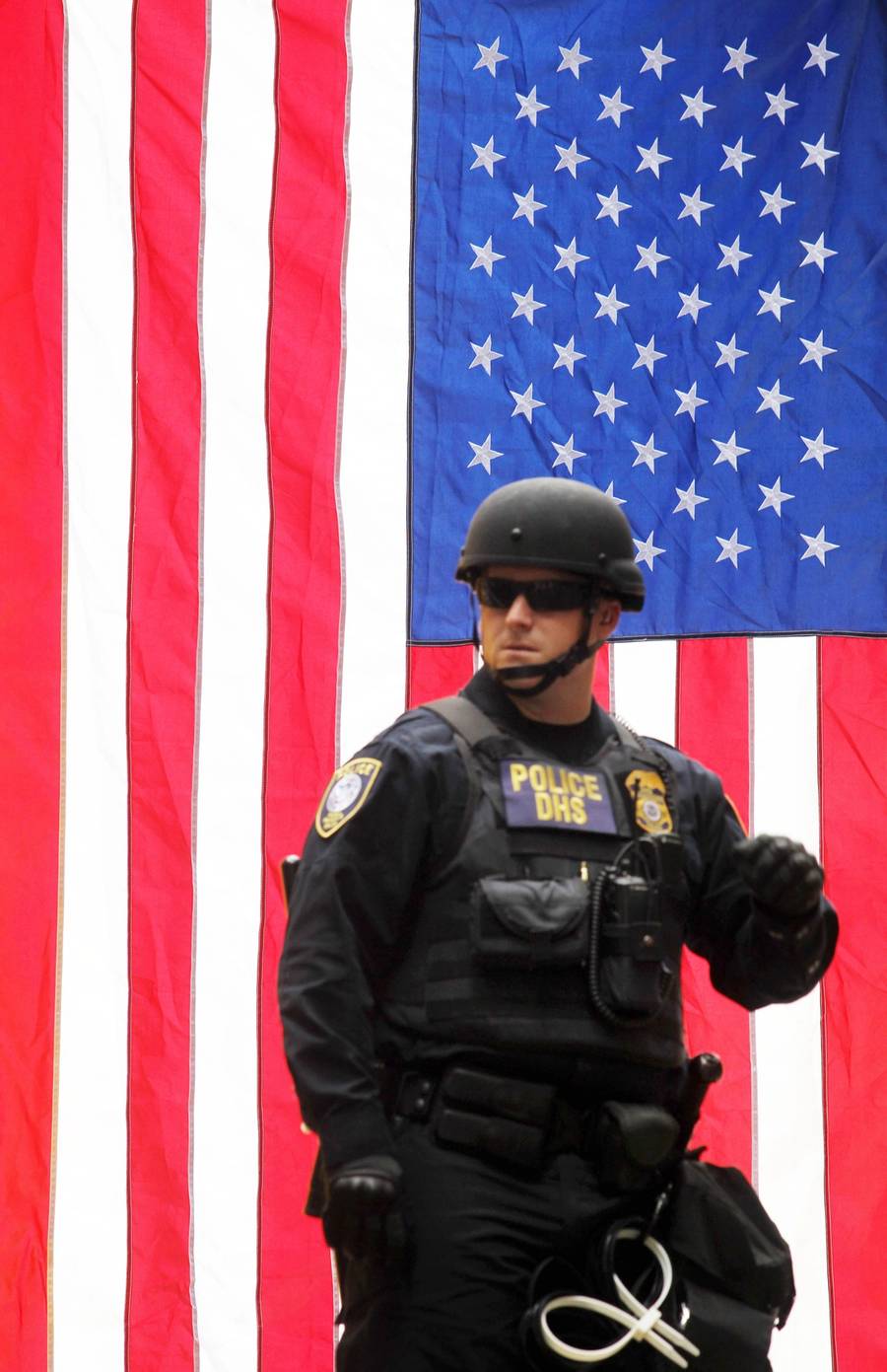 A DHS police officer in front of an American flag at a right-wing rally in Portland, Oregon, on June 4, 2017