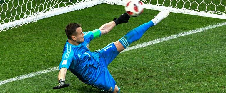 Russia's goalkeeper Igor Akinfeev saves the ball in a penalty shootout leading to Russia winning the Russia 2018 World Cup Round of 16 football match between Spain and Russia at the Luzhniki Stadium in Moscow on July 1, 2018.
