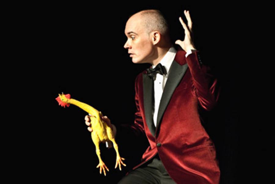 Shane Baker performs a magic trick with a rubber chicken, in 'The Big Bupkis'(Photo © Jordan McAfee)