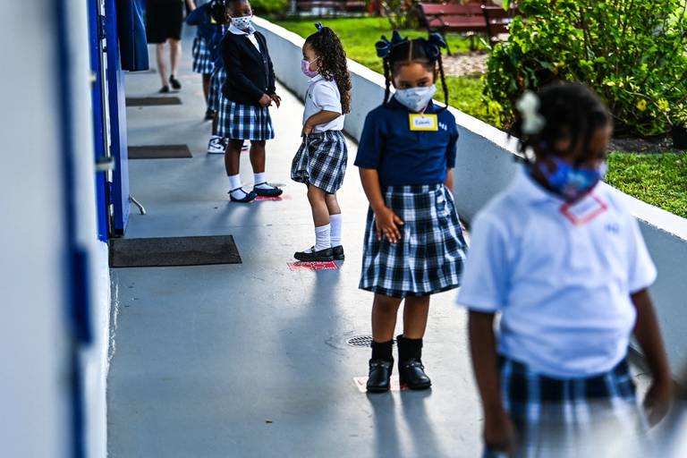 Students on their first day of school after summer vacation at the St. Lawrence Catholic School north of Miami, on Aug. 18, 2021