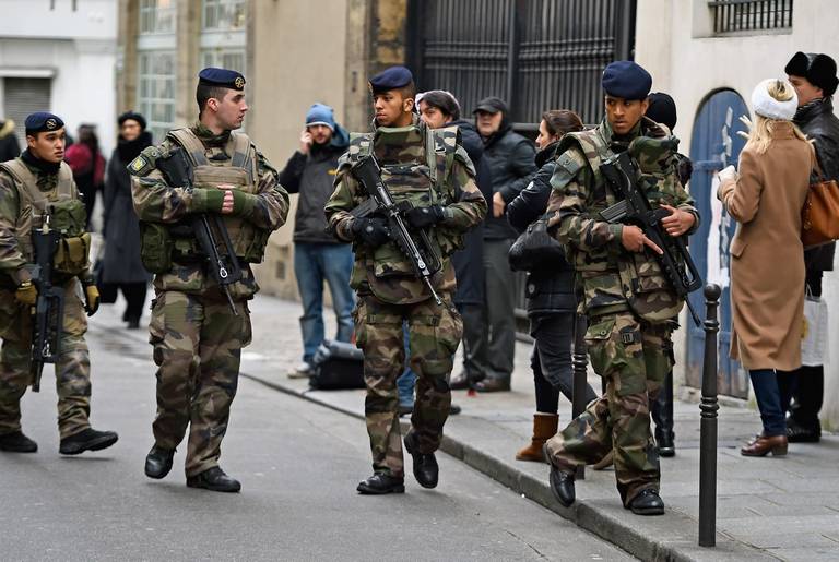 Armed soldiers patrol outside a school in the Jewish quarter of the Marais district on January 13, 2015 in Paris, France. (Jeff J Mitchell/Getty Images)