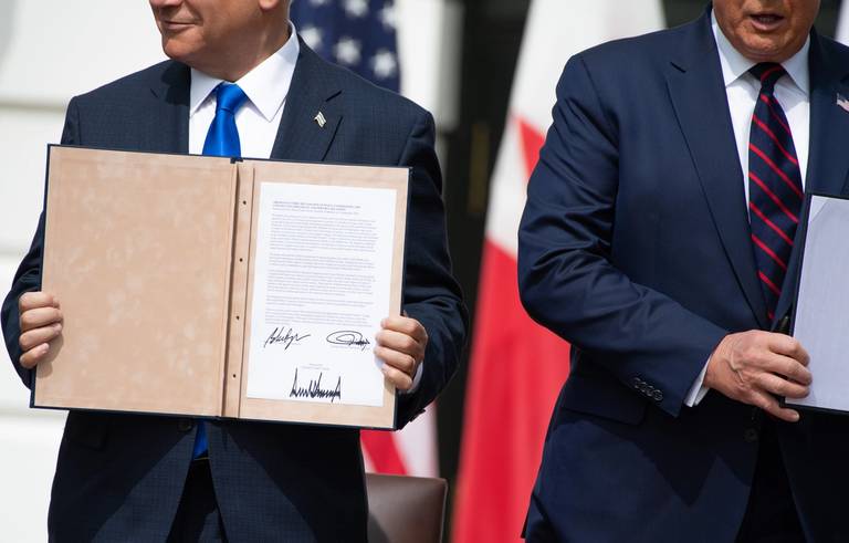 Israeli Prime Minister Benjamin Netanyahu, at left, holds up the document after participating in the signing of the Abraham Accords, in which Bahrain and the United Arab Emirates recognize Israel, at the White House in Washington, D.C., Sept. 15, 2020
