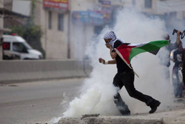 A Palestinian protester yesterday during clashes at the Qalandiya checkpoint, in the West Bank.(Uriel Sinai/Getty Images)