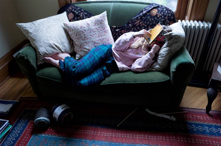 A teenager reads a school English assignment at home after her Brooklyn school shut down because of the COVID-19 pandemic, on March 22, 2020