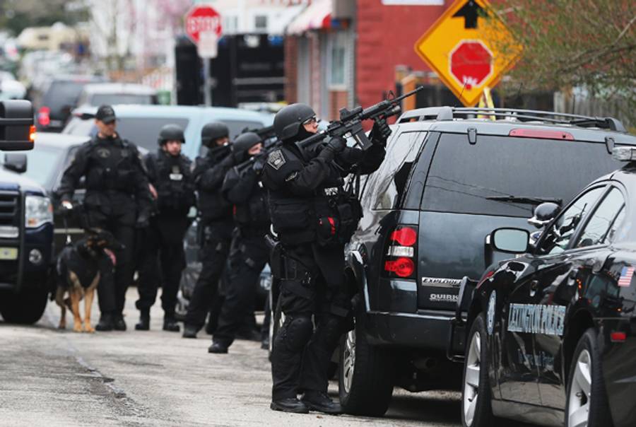 A Boston SWAT team member takes up as posistion as they search for 19-year-old bombing suspect Dzhokhar A. Tsarnaev on April 19, 2013 in Watertown, Massachusetts.(Mario Tama/Getty Images)