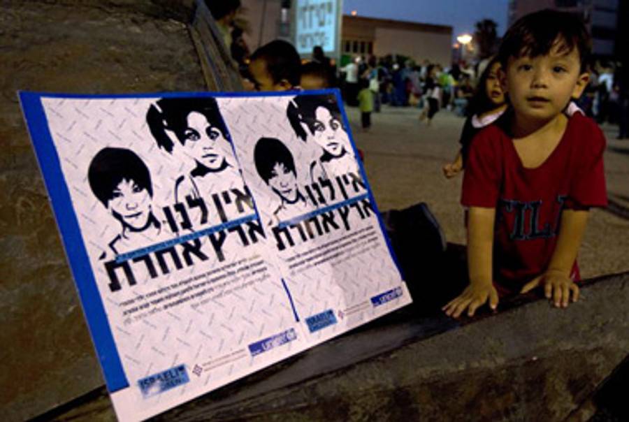The child of immigrants plays during a Tel Aviv protest last month calling on the Israeli government to allow illegal immigrants to stay in the country.(Jack Guez/AFP/Getty Images)