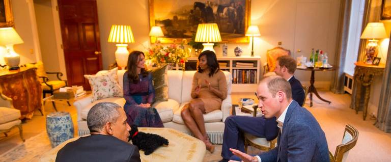 Prince William, Duke of Cambridge, speaks with U.S. President Barack Obama as Catherine, Duchess of Cambridge, speaks with First Lady of the United States Michelle Obama and Prince Harry in the Drawing Room of Apartment 1A Kensington Palace in London, England, April 22, 2016. 
