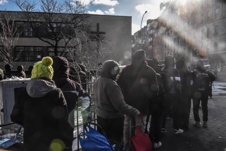 Homeless migrants wait in line to receive food and clothing donations in Tompkins Square Park in New York City on Jan. 20, 2024