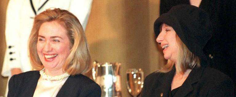 Hillary Clinton and Barbra Streisand talk prior to a speech by President Bill Clinton at a luncheon sponsored by the United Jewish Fund  in Beverly Hills, California, April 9, 1995. 