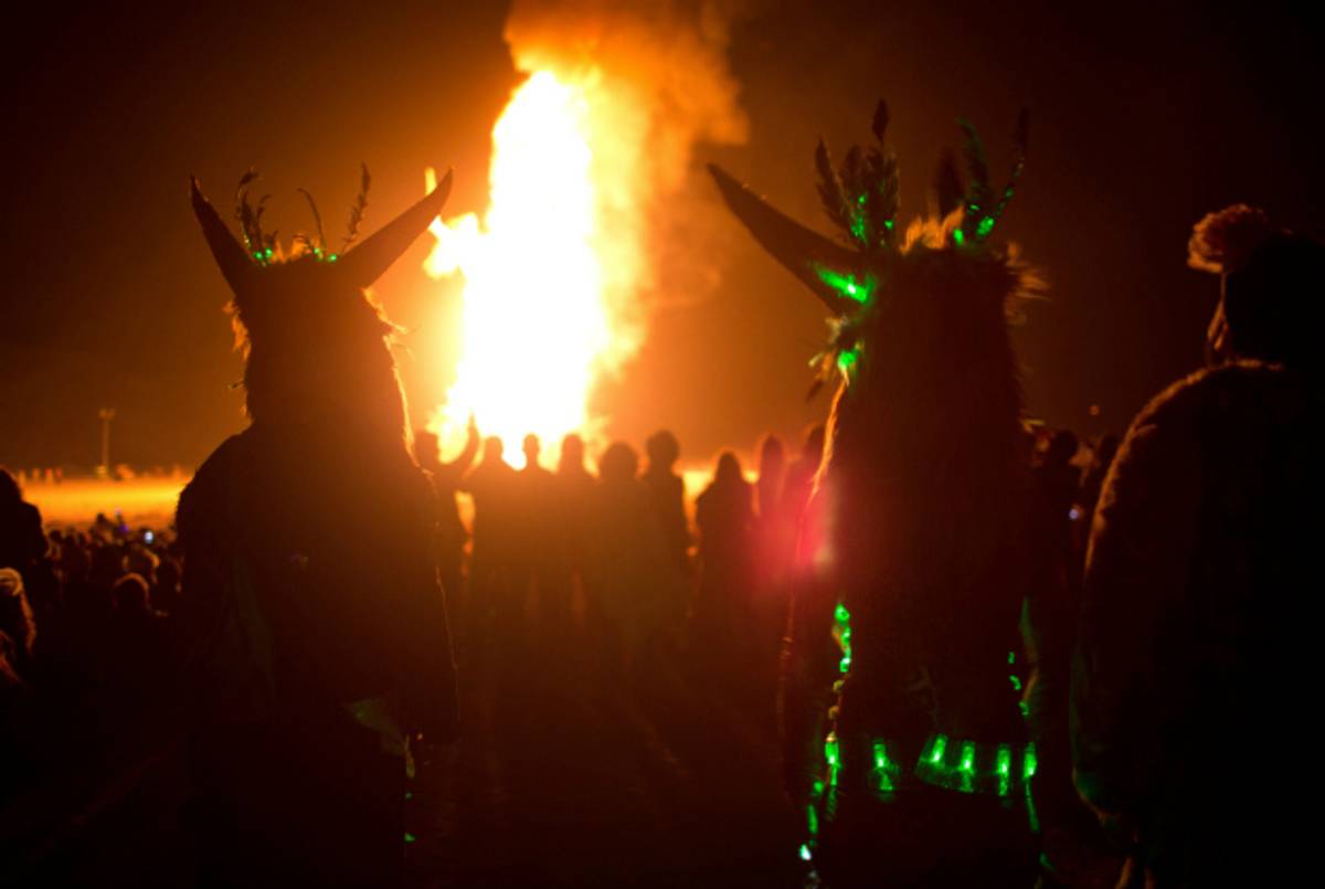 Cosplayers watch a wooden effigy burn at Midburn festival in Israeli, May 22, 2015. (Menahem Kahana/AFP/Getty Images)