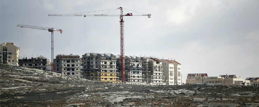 Israeli construction cranes and excavators at a building site of new housing units in the Jewish settlement of Kochav Ya'akov near the West Bank city of Ramallah (top), January 3, 2017. 