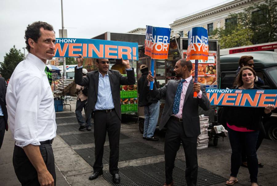 New York City mayoral hopeful Anthony Weiner meets with people on a street corner In Harlem on September 10, 2013 in New York City. (Andrew Burton/Getty Images)