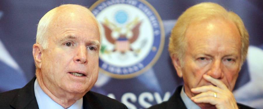 Sen. John McCain, at left, speaks as Sen. Joseph Lieberman looks on during a press conference at a hotel in Kuala Lumpur on May 31, 2012.