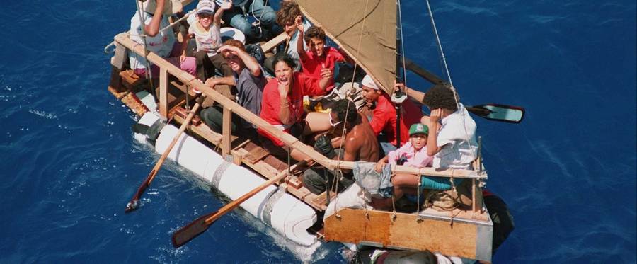 Cuban refugees including children sail on a raft in an attempt to reach the United States off the coast of Cuba 31 August 1994. The numbers of Cuban boat-people refugees increased in the summer of 1994 in spite of Bill Clinton's warning that Cubans are no longer welcome in the US.