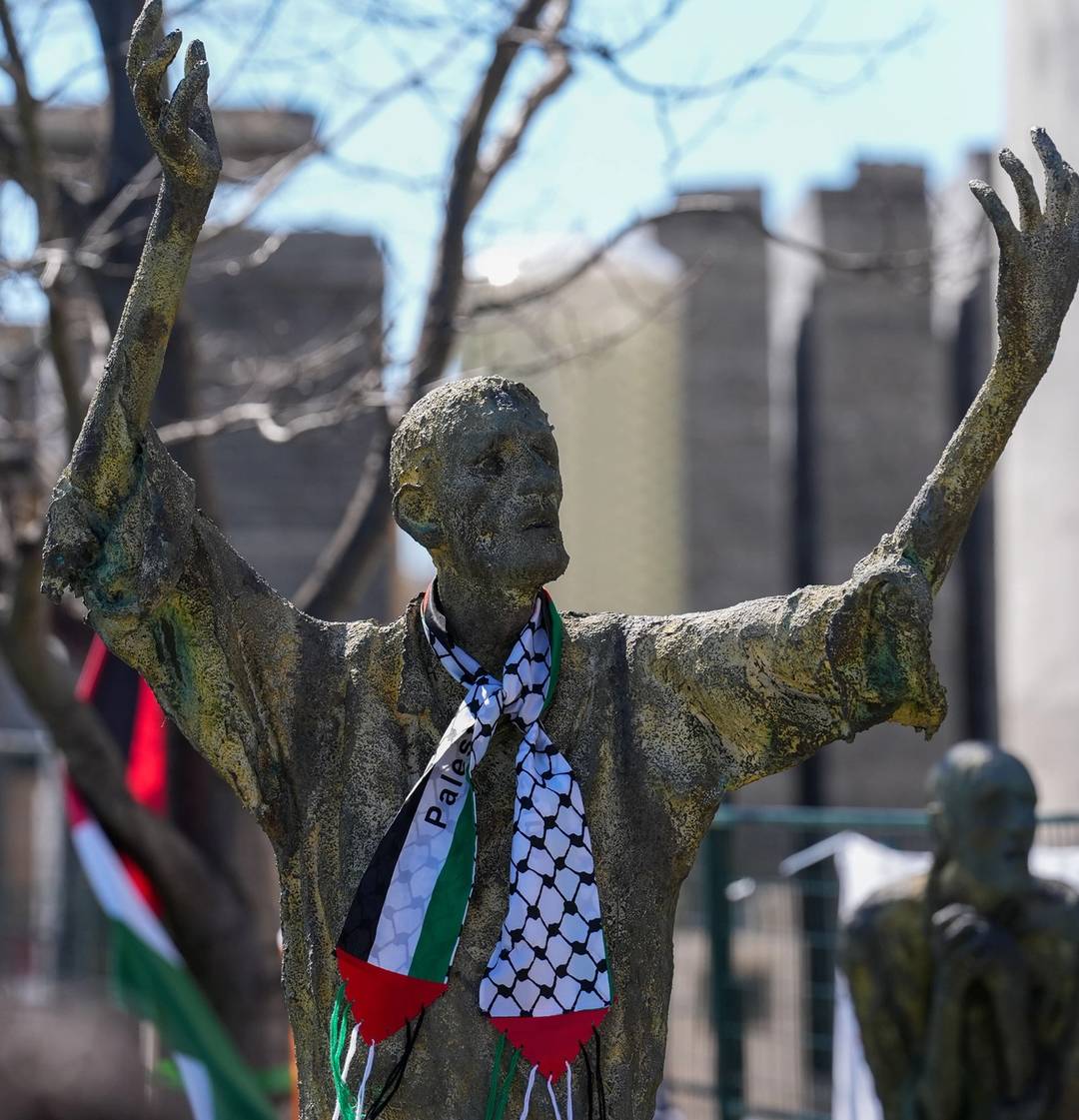 Bronze statues depicting the Irish Famine are decorated with a Palestinian scarf during the 'Irish for Palestine' vigil, Ireland Park, Toronto, April 7, 2024