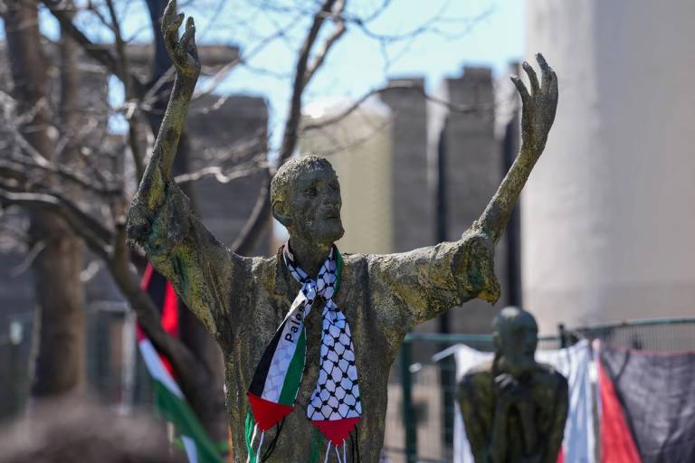 Bronze statues depicting the Irish Famine are decorated with a Palestinian scarf during the 'Irish for Palestine' vigil, Ireland Park, Toronto, April 7, 2024
