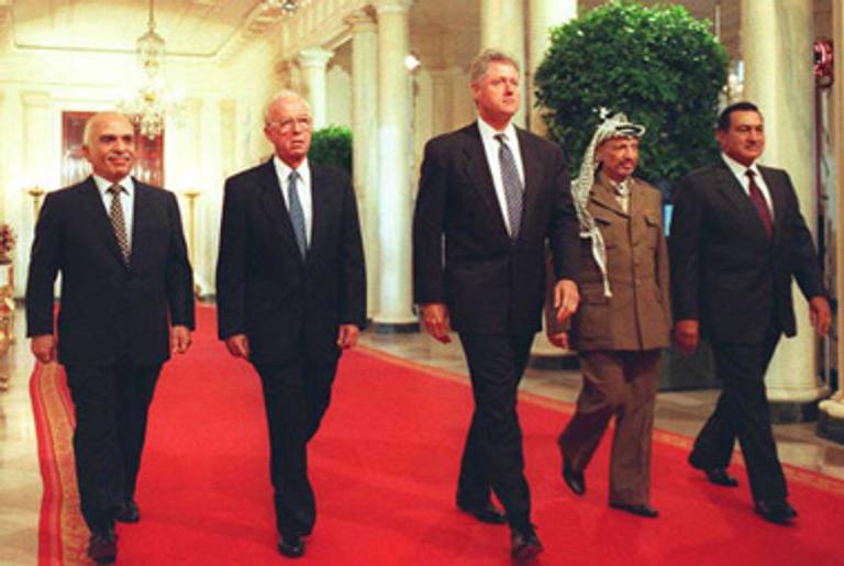King Hussein of Jordan, Israeli Prime Minister Yitzhak Rabin, President Bill Clinton, PLO Chairman Yasser Arafat, and Egyptian President Hosni Mubarak walk to the White House’s East Room to sign a West Bank autonomy accord, September 28, 1995.(AFP/Getty Images)