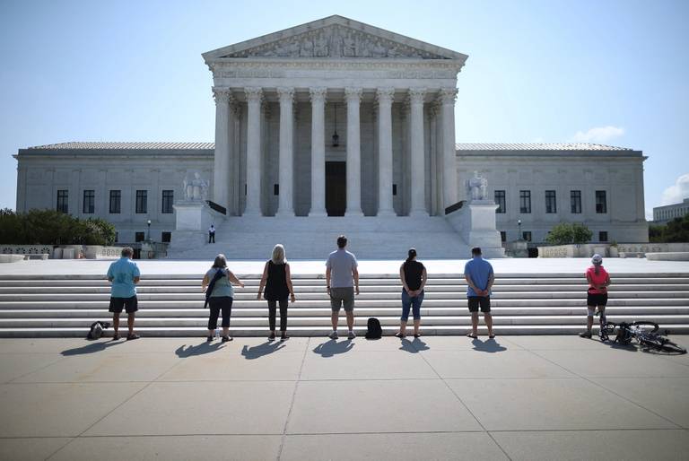  Anti-abortion demonstrators pray in front of the U.S. Supreme Court in Washington, D.C., July 08, 2020