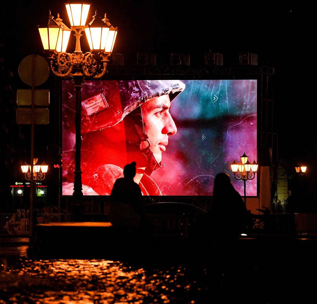 A screen displays patriotic videos in Yerevan during  the Nagorno-Karabakh war, on Oct. 5, 2020