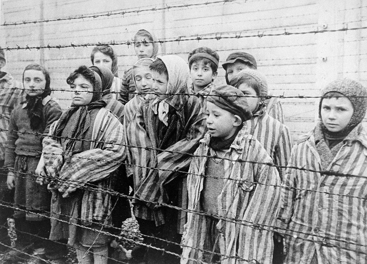 Child survivors during the liberation of Auschwitz. Eva and her twin sister, Miriam, appear at the far right, both wearing knitted hats. The photo is a still from the Soviet film of the liberation of Auschwitz, taken by the film unit of the First Ukrainian Front, shot over a period of several months beginning on Jan. 27, 1945, by Alexander Voronzow.